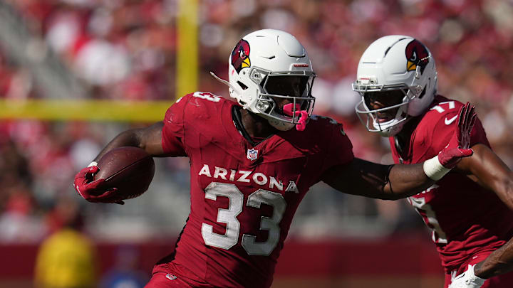 Sep 21, 2025; Santa Clara, California, USA; Arizona Cardinals running back Trey Benson (33) carries the ball as San Francisco 49ers safety Jason Pinnock (25) defends during the second half at Levi's Stadium. Mandatory Credit: Cary Edmondson-Imagn Images