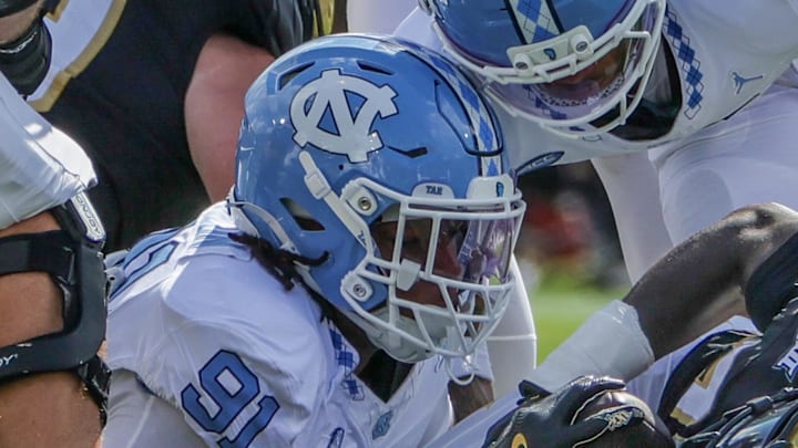 Sep 20, 2025; Orlando, Florida, USA; UCF Knights running back Myles Montgomery (22) is tackled by North Carolina Tar Heels defensive lineman Leroy Jackson (91) during the first quarter at the Bounce House Stadium. Mandatory Credit: Mike Watters-Imagn Images