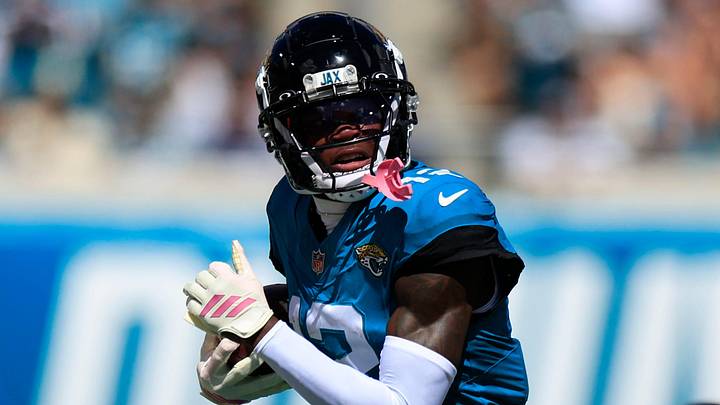 Jacksonville Jaguars wide receiver Travis Hunter (12) rushes for yards against Seattle Seahawks safety Nick Emmanwori (3) during the first quarter of an NFL football matchup, Sunday, Oct. 12, 2025, at EverBank Stadium in Jacksonville, Fla.