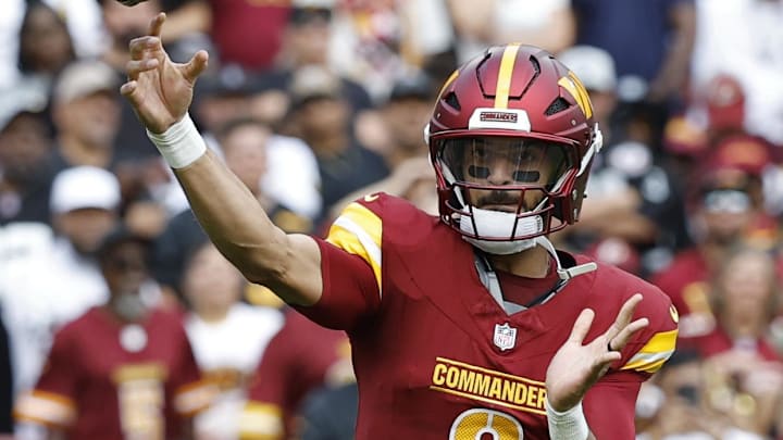 Sep 21, 2025; Landover, Maryland, USA; Washington Commanders quarterback Marcus Mariota (8) throws a pass to Commanders wide receiver Deebo Samuel Sr. (1) against the Las Vegas Raiders during the first quarter at Northwest Stadium. Mandatory Credit: Geoff Burke-Imagn Images