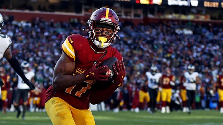 Dec 22, 2024; Landover, Maryland, USA; Washington Commanders wide receiver Terry McLaurin (17) catches a touchdown  pass against Philadelphia Eagles cornerback Quinyon Mitchell (27) during the second quarter at Northwest Stadium. Mandatory Credit: Peter Casey-Imagn Images