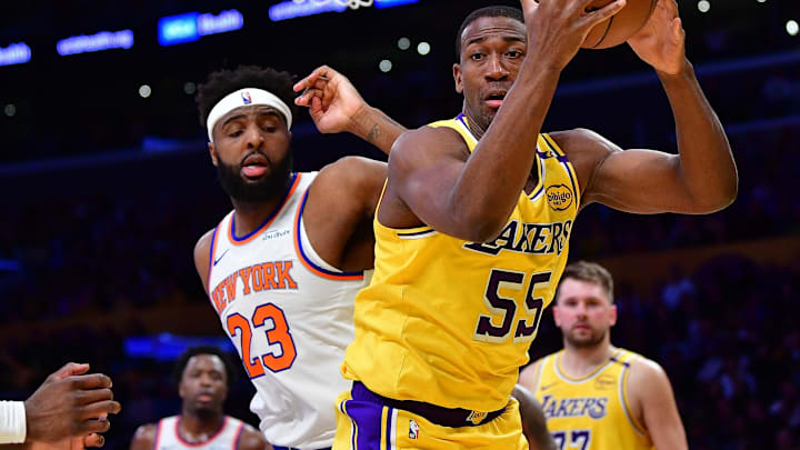 Mar 6, 2025; Los Angeles, California, USA; Los Angeles Lakers center Trey Jemison III (55) gets the rebound against New York Knicks center Mitchell Robinson (23) during the first half at Crypto.com Arena. Mandatory Credit: Gary A. Vasquez-Imagn Images