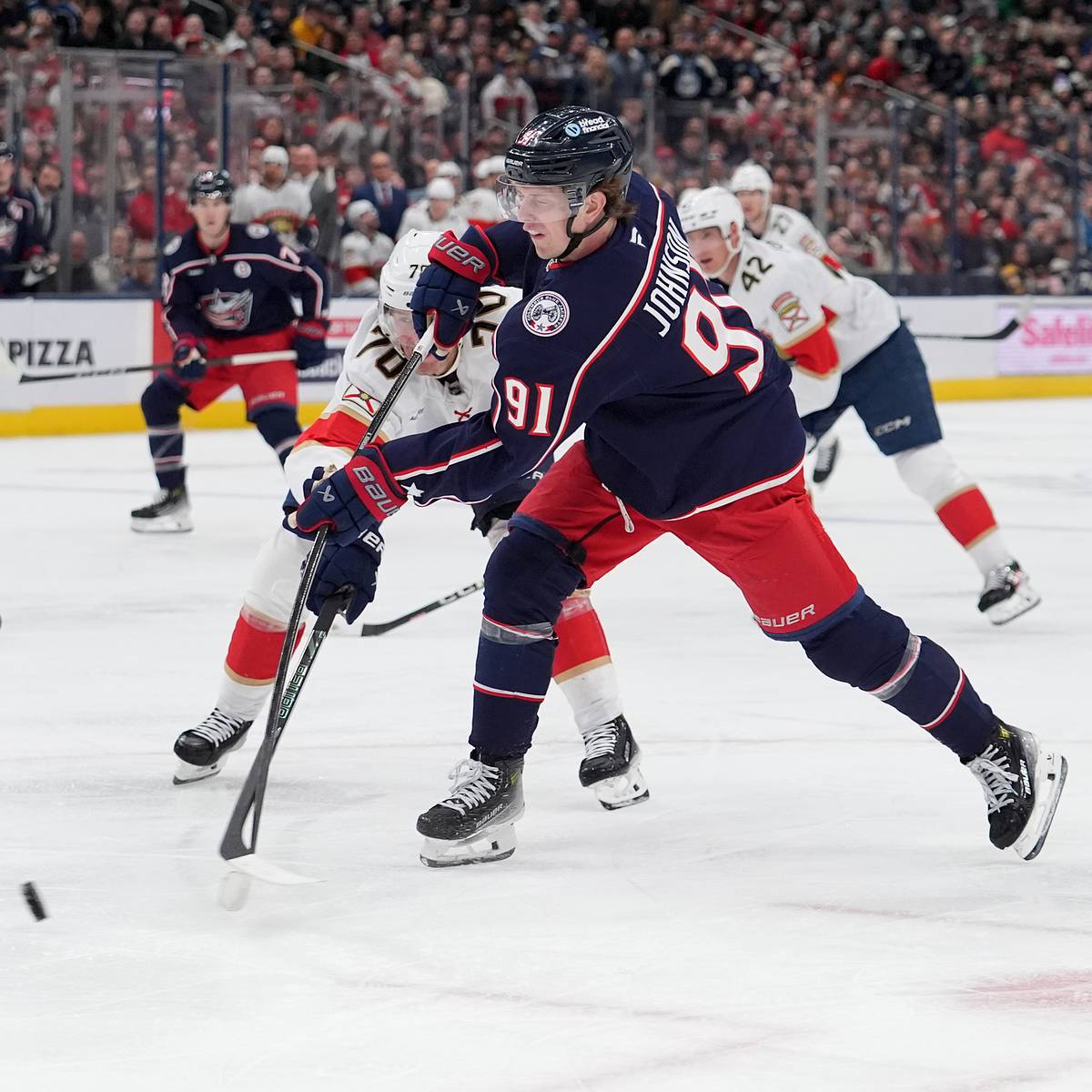 Columbus Blue Jackets forward Kent Johnson carrying the puck