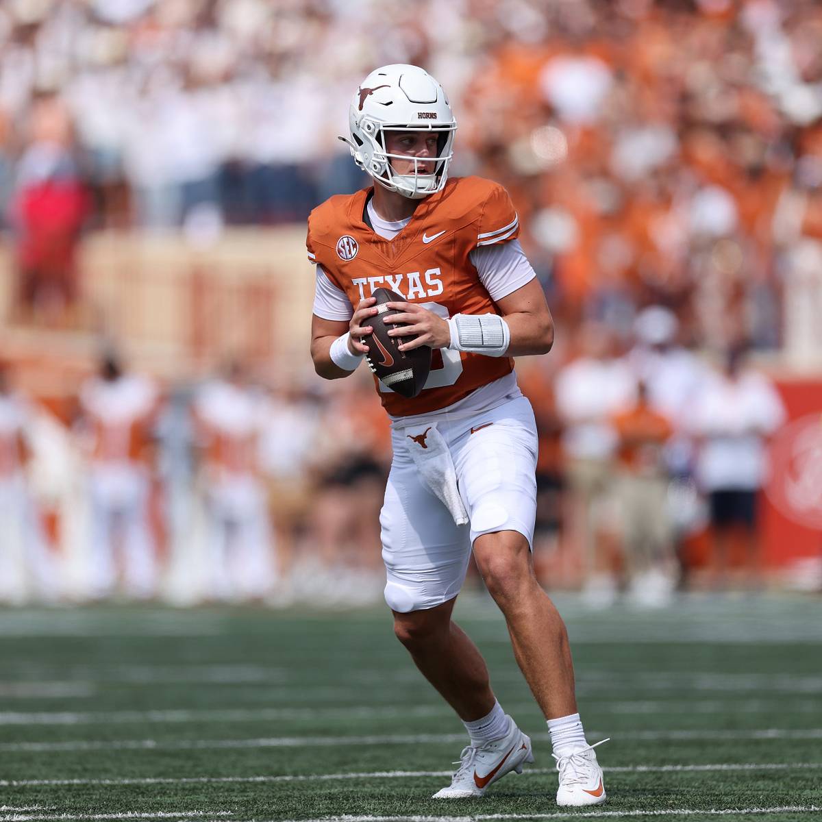 Arch Manning holds the football while preparing to make a play for Texas