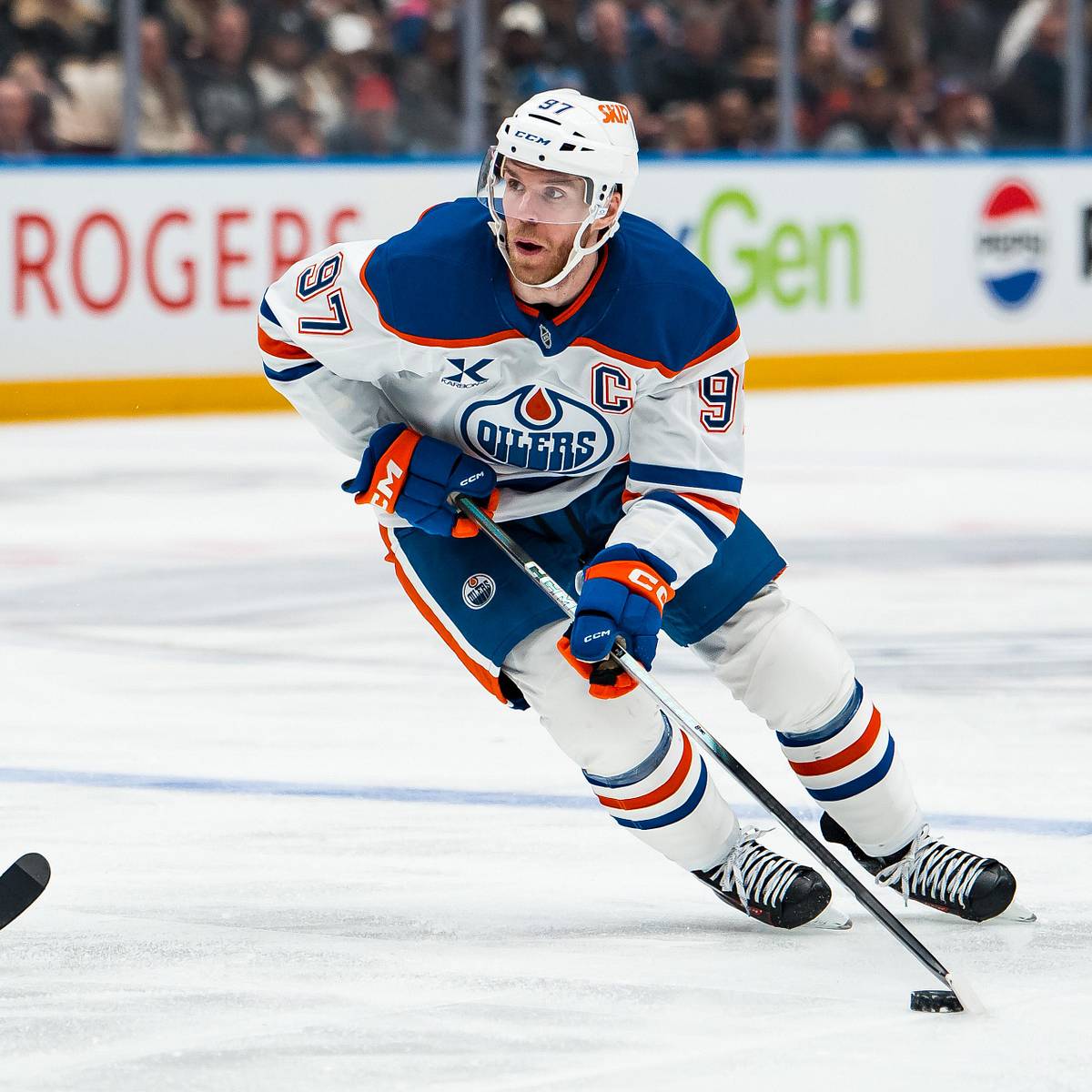 Connor McDavid in Edmonton Oilers colors carrying the puck during 2026 NHL play