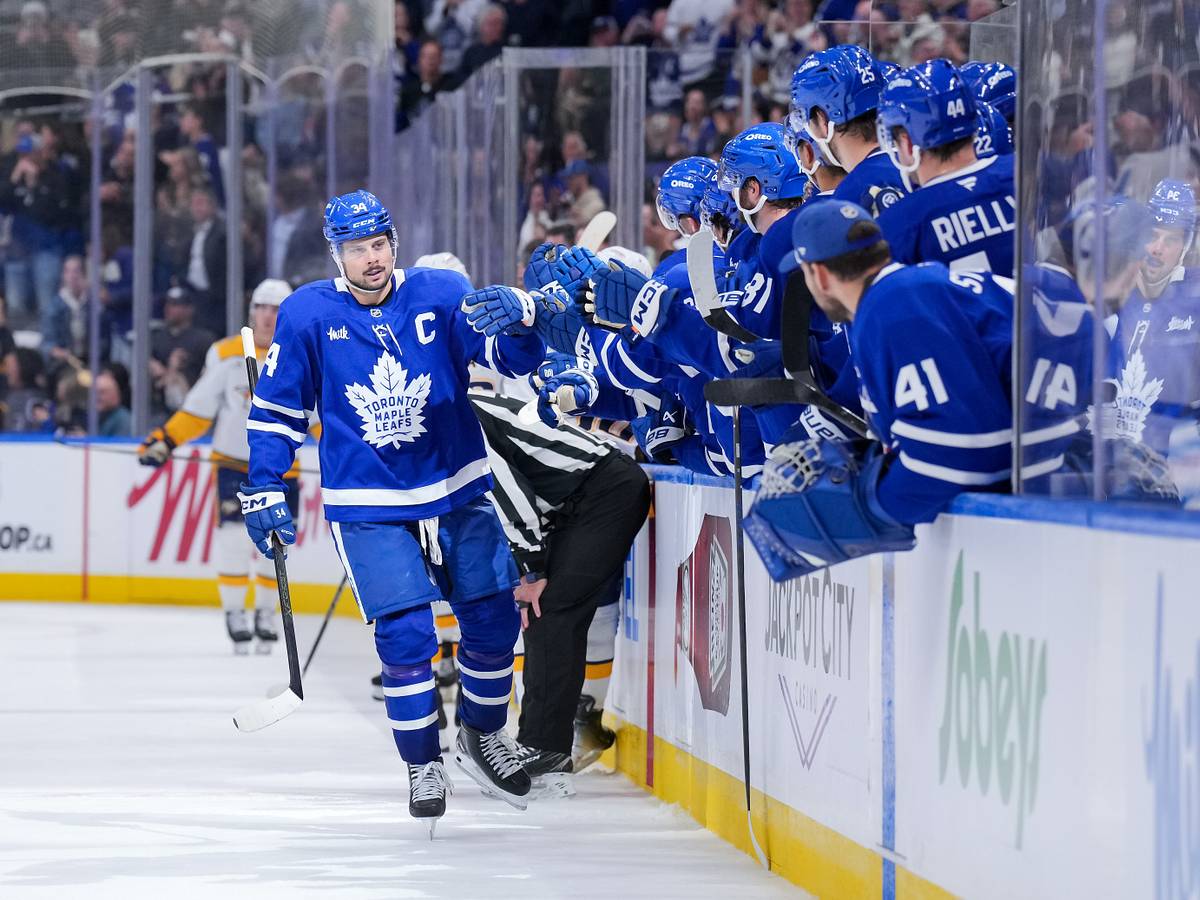 Auston Matthews celebrates with the Toronto Maple Leafs bench