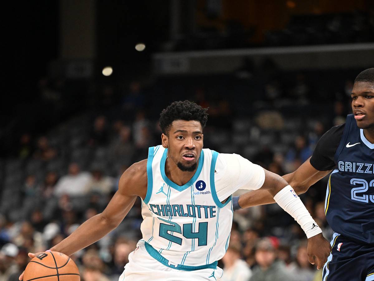 Brandon Miller drives with the ball in Charlotte's white and teal uniform during 2025-26