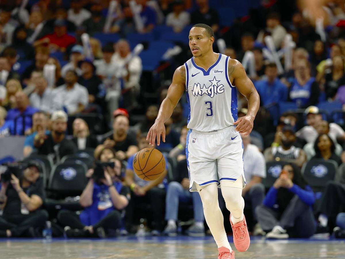 Desmond Bane brings the ball upcourt in a white Orlando Magic jersey