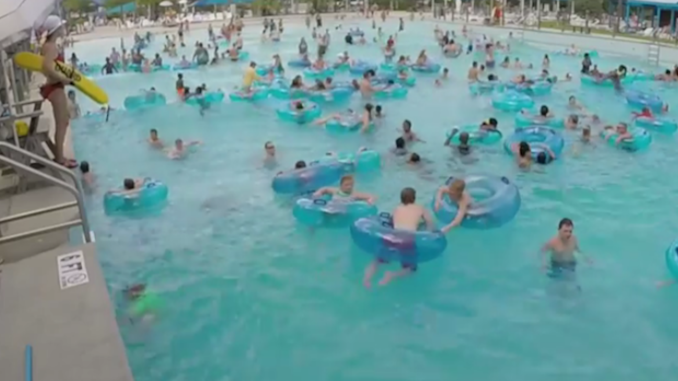 Lifeguard spots drowning child in sea of people in amazing 