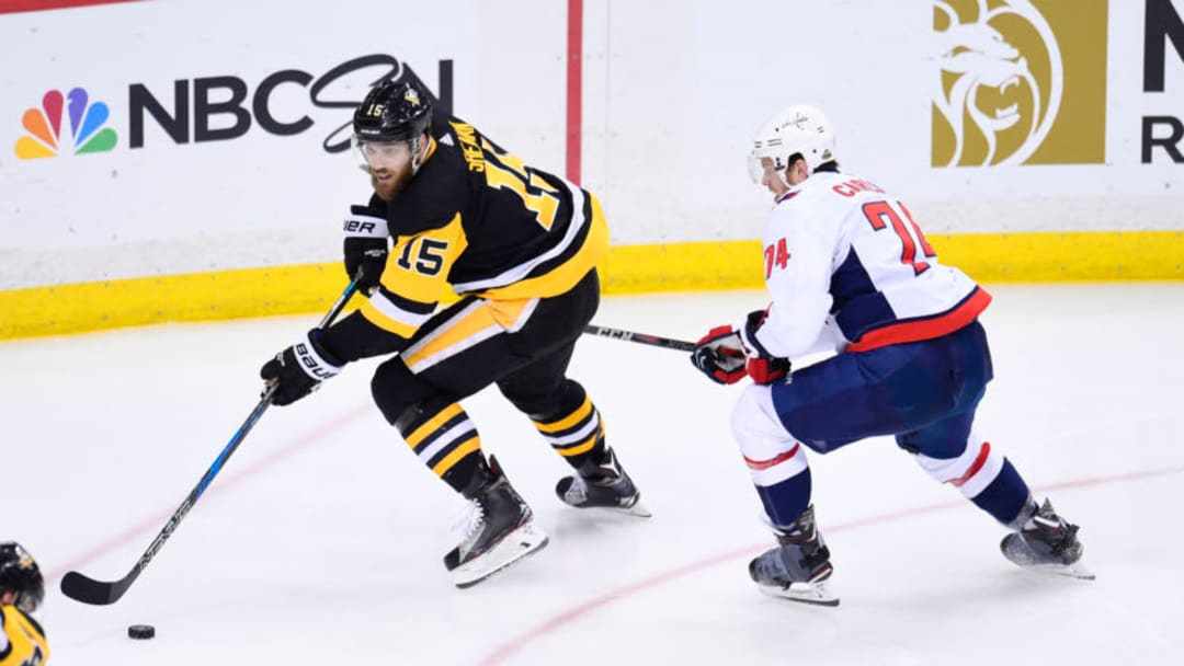 PITTSBURGH, PA - MAY 07: Pittsburgh Penguins center Riley Sheahan (15) handles the puck while Washington Capitals Defenseman John Carlson (74) defends during the overtime period. The Washington Capitals went on win 2-1 in the overtime period against the Pittsburgh Penguins in Game Six of the Eastern Conference Second Round during the 2018 NHL Stanley Cup Playoffs on May 7, 2018, at PPG Paints Arena in Pittsburgh, PA. The Capitals won the series 4-2 and advance to the Eastern Conference Final. (Photo by Jeanine Leech/Icon Sportswire via Getty Images)