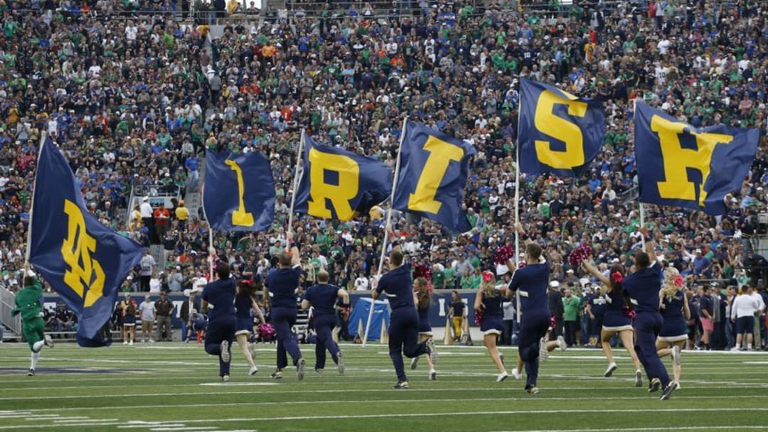 Oct 29, 2016; South Bend, IN, USA; Notre Dame Fighting Irish cheerleaders run with flags after a Notre Dame score against the Miami Hurricanes at Notre Dame Stadium. Mandatory Credit: Brian Spurlock-USA TODAY Sports