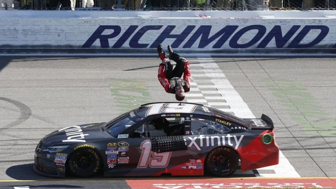 Apr 24, 2016; Richmond, VA, USA; Sprint Cup Series driver Carl Edwards (19) flips off the side of his car after winning the Toyota Owners 400 at Richmond International Raceway. Mandatory Credit: Amber Searls-USA TODAY Sports