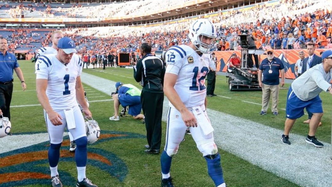 Sep 18, 2016; Denver, CO, USA; Indianapolis Colts quarterback Andrew Luck (12) walks off the field with punter Pat McAfee (1) following the game against the Denver Broncos at Sports Authority Field at Mile High. The Broncos won 34-20. Mandatory Credit: Isaiah J. Downing-USA TODAY Sports