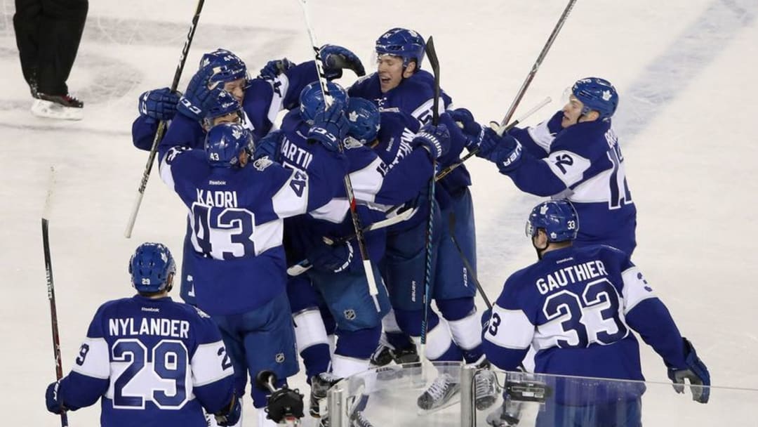 Jan 1, 2017; Toronto, Ontario, CAN; Toronto Maple Leafs center Auston Matthews (34) is congratulated by teammates after scoring the game-winning goal in overtime against the Detroit Red Wings during the Centennial Classic ice hockey game at BMO Field. The Maple Leafs beat the Red Wings 5-4 in overtime. Mandatory Credit: Tom Szczerbowski-USA TODAY Sports