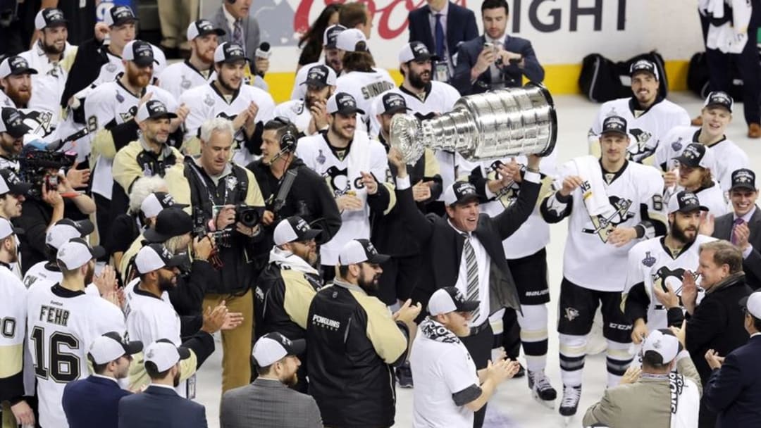 Jun 12, 2016; San Jose, CA, USA; Pittsburgh Penguins head coach Mike Sullivan hoists the Stanley Cup after defeating the San Jose Sharks in game six of the 2016 Stanley Cup Final at SAP Center at San Jose. Mandatory Credit: John Hefti-USA TODAY Sports