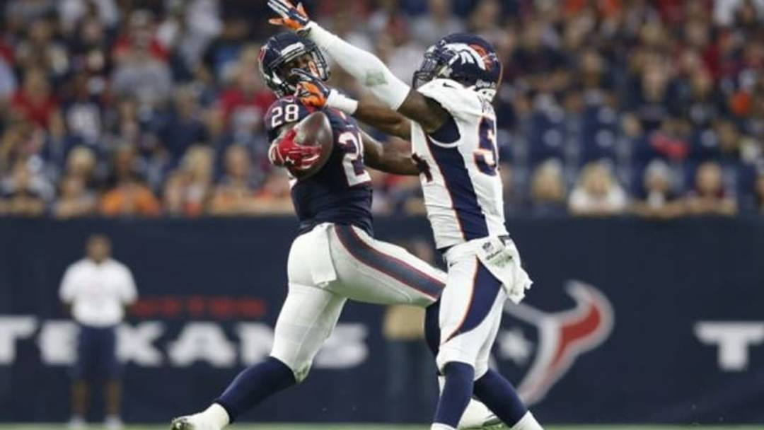 Aug 22, 2015; Houston, TX, USA; Houston Texans running back Alfred Blue (28) attempts to catch a pass during the first quarter as Denver Broncos outside linebacker Brandon Marshall (54) defends at NRG Stadium. Mandatory Credit: Matthew Emmons-USA TODAY Sports