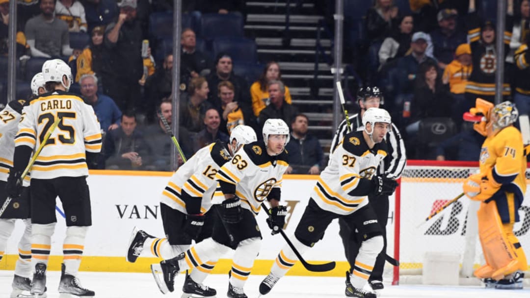 Feb 16, 2023; Nashville, Tennessee, USA; Boston Bruins left wing Brad Marchand (63) celebrates with teammates after a goal during the first period against the Nashville Predators at Bridgestone Arena. Mandatory Credit: Christopher Hanewinckel-USA TODAY Sports