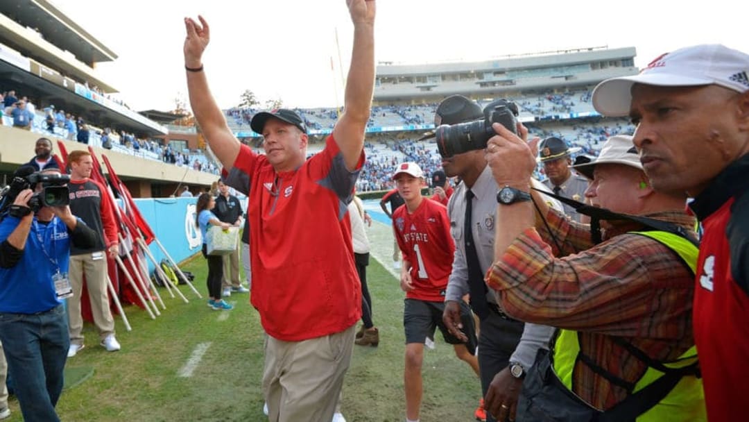 CHAPEL HILL, NC - NOVEMBER 25: Head coach Dave Doeren of the North Carolina State Wolfpack reacts as he leaves the field after a win against the North Carolina Tar Heels at Kenan Stadium on November 25, 2016 in Chapel Hill, North Carolina. North Carolina State won 28-21. (Photo by Grant Halverson/Getty Images)