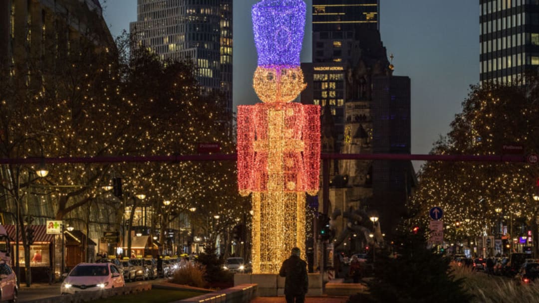 BERLIN, GERMANY - NOVEMBER 24: People walk on decorated Kurfürstendamm avenue on November 24, 2020 in Berlin, Germany. The Christmas season is beginning muted in Berlin, with traditional Christmas markets that would normally open today all cancelled. Germany is in the midst of November semi-lockdown measures that political leaders will likely be extended until December 20 as authorities continue to struggle to bring down coronavirus infection rates. (Photo by Maja Hitij/Getty Images)