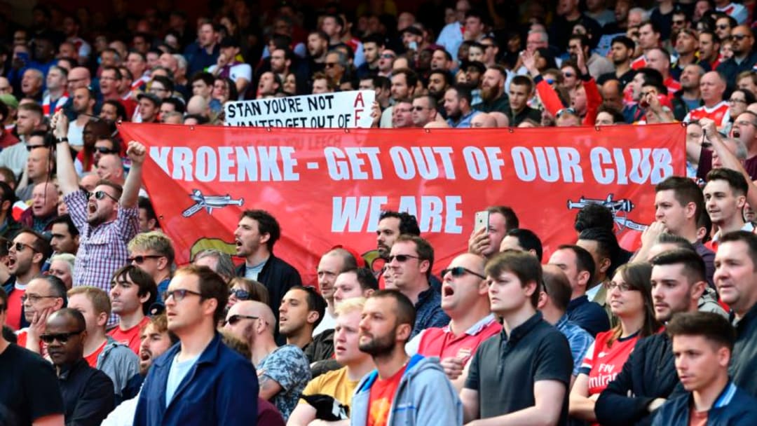 Arsenal fans hold up a banner against Arsenal's majority owner Stan Kroenke during the English Premier League football match between Arsenal and Everton at the Emirates Stadium in London on May 21, 2017. / AFP PHOTO / Justin TALLIS / RESTRICTED TO EDITORIAL USE. No use with unauthorized audio, video, data, fixture lists, club/league logos or 'live' services. Online in-match use limited to 75 images, no video emulation. No use in betting, games or single club/league/player publications. / (Photo credit should read JUSTIN TALLIS/AFP/Getty Images)