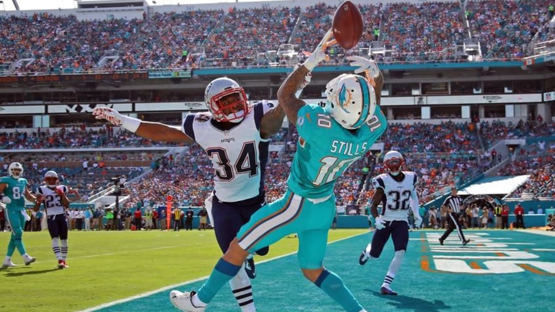 Jan 3, 2016; Miami Gardens, FL, USA; Miami Dolphins wide receiver Kenny Stills (10) is unable to make a catch in the end zone as New England Patriots cornerback Leonard Johnson (34) defends the play during the first half at Sun Life Stadium. Mandatory Credit: Steve Mitchell-USA TODAY Sports