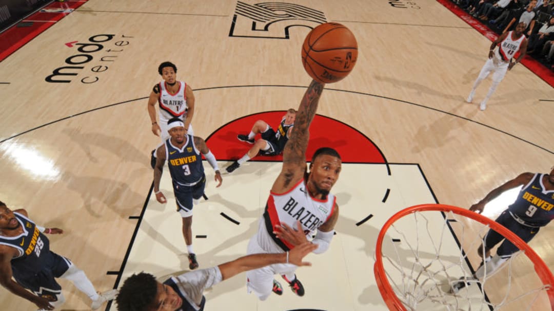 PORTLAND, OR - OCTOBER 23: Damian Lillard #0 of the Portland Trail Blazers dunks the ball against the Denver Nuggets on October 23, 2019 at the Moda Center Arena in Portland, Oregon. NOTE TO USER: User expressly acknowledges and agrees that, by downloading and or using this photograph, user is consenting to the terms and conditions of the Getty Images License Agreement. Mandatory Copyright Notice: Copyright 2019 NBAE (Photo by Cameron Browne/NBAE via Getty Images)