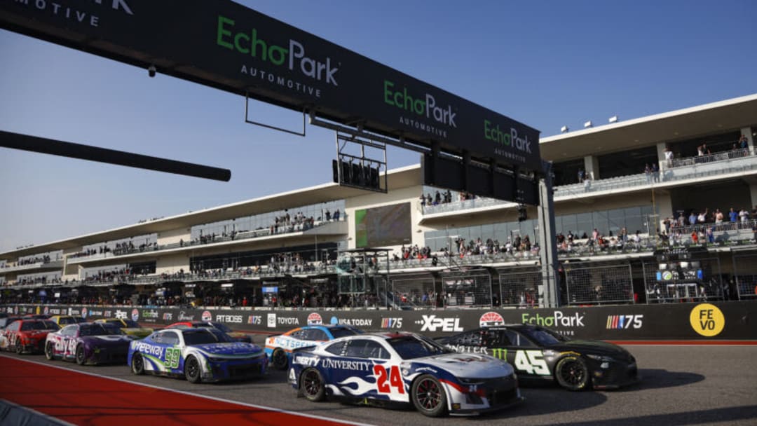 AUSTIN, TEXAS - MARCH 26: William Byron, driver of the #24 Liberty University Chevrolet, and Tyler Reddick, driver of the #45 Monster Energy Toyota, lead the field to an overtime restart during the NASCAR Cup Series EchoPark Automotive Grand Prix at Circuit of The Americas on March 26, 2023 in Austin, Texas. (Photo by Sean Gardner/Getty Images)