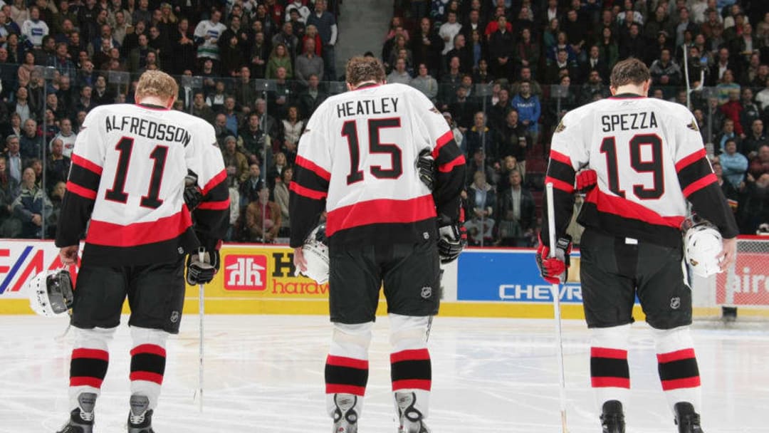 VANCOUVER - DECEMBER 9: Daniel Alfredsson #11, Dany Heatley #15 and Jason Spezza #19 of the Ottawa Senators line up during the National Anthem before the NHL game against the Vancouver Canucks at General Motors Place on December 9, 2005 in Vancouver, Canada. The Canucks defeated the Senators 3-2. (Photo by Jeff Vinnick/Getty Images)