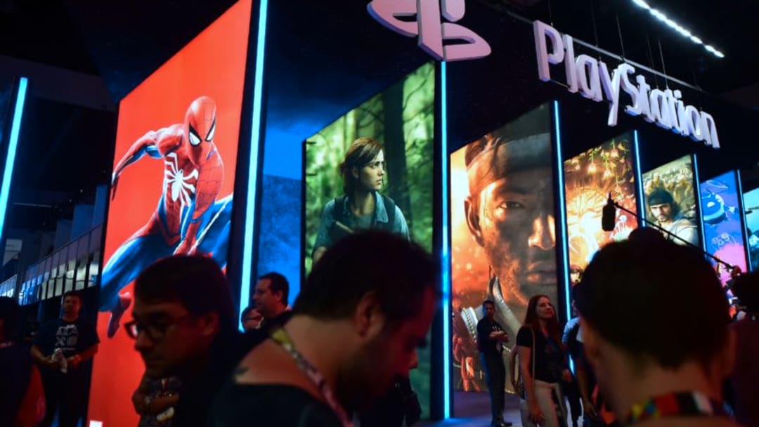 People wander in front of the Playstation posters at the 24th Electronic Expo, or E3 2018, in Los Angeles, California on June 12, 2018, where hardware manufacturers, software developers and the video game industry present their new games. (Photo by Frederic J. BROWN / AFP) (Photo credit should read FREDERIC J. BROWN/AFP/Getty Images)