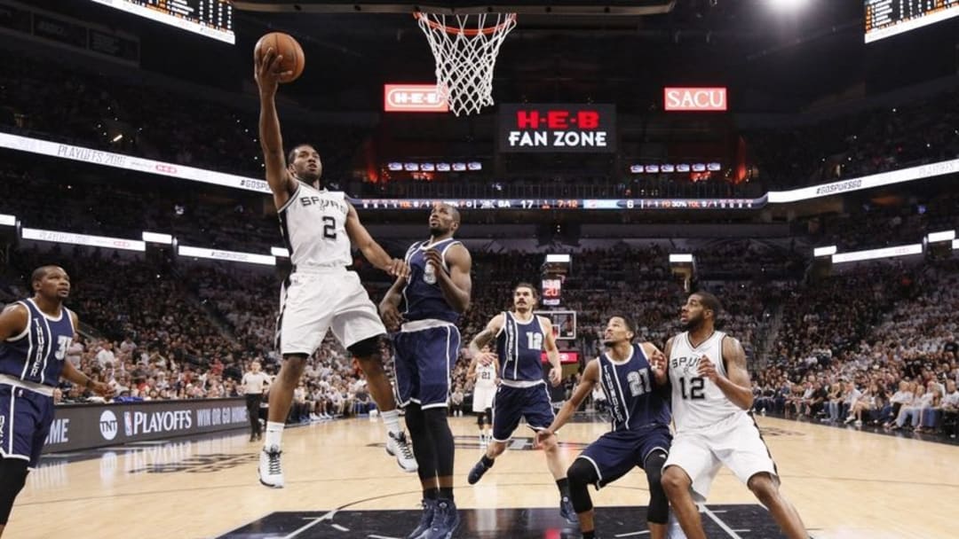 Apr 30, 2016; San Antonio, TX, USA; San Antonio Spurs small forward Kawhi Leonard (2) shoots the ball as Oklahoma City Thunder power forward Serge Ibaka (9) defends in game one of the second round of the NBA Playoffs at AT&T Center. Mandatory Credit: Soobum Im-USA TODAY Sports