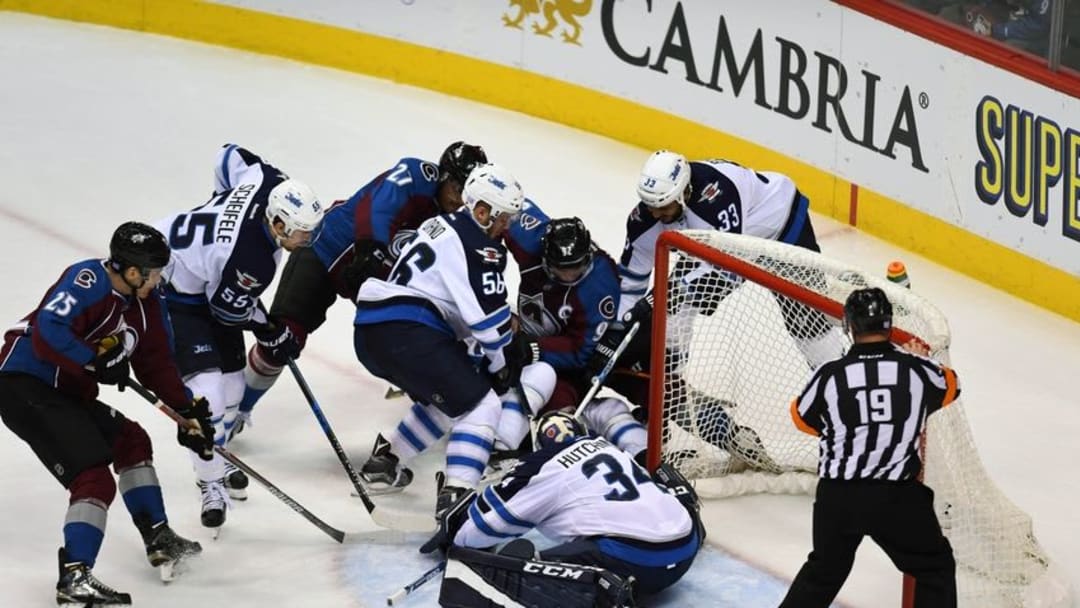 Nov 11, 2016; Denver, CO, USA; Colorado Avalanche center Mikhail Grigorenko (25) and left wing Andreas Martinsen (27) and center Matt Duchene (9) attempt to score past goalie Michael Hutchinson (34) as center Mark Scheifele (55) and center Marko Dano (56) and defenseman Dustin Byfuglien (33) defend the post in the second period at Pepsi Center. Mandatory Credit: Ron Chenoy-USA TODAY Sports