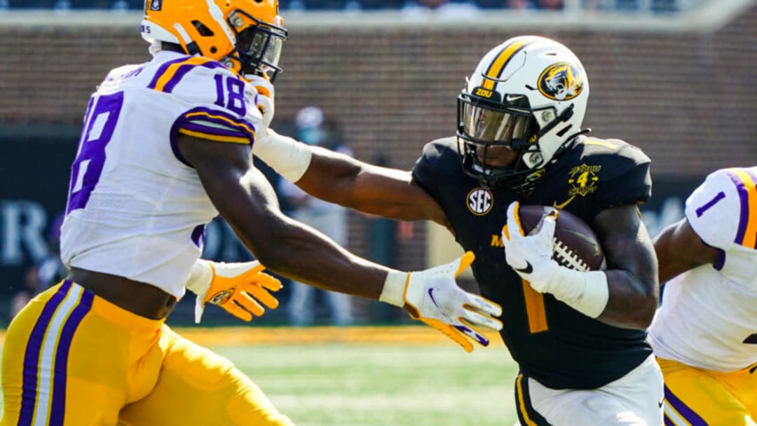 Oct 10, 2020; Columbia, Missouri, USA; Missouri Tigers running back Tyler Badie (1) stiff arms LSU Tigers linebacker Damone Clark (18) during the second half at Faurot Field at Memorial Stadium. Mandatory Credit: Jay Biggerstaff-USA TODAY Sports