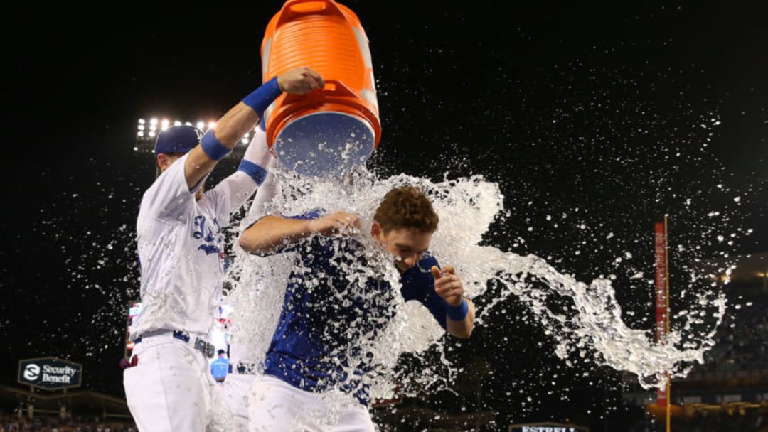 LOS ANGELES, CALIFORNIA - JUNE 01: Will Smith #16 of the Los Angeles Dodgers is doused with a bucket of water by teammates Cody Bellinger #35 and Joc Pederson #31 after Smith hit a walk-off homerun in the ninth inning of the MLB game against the Philadelphia Phillies at Dodger Stadium on June 01, 2019 in Los Angeles, California. The Dodgers defeated the Phillies 4-3. (Photo by Victor Decolongon/Getty Images)