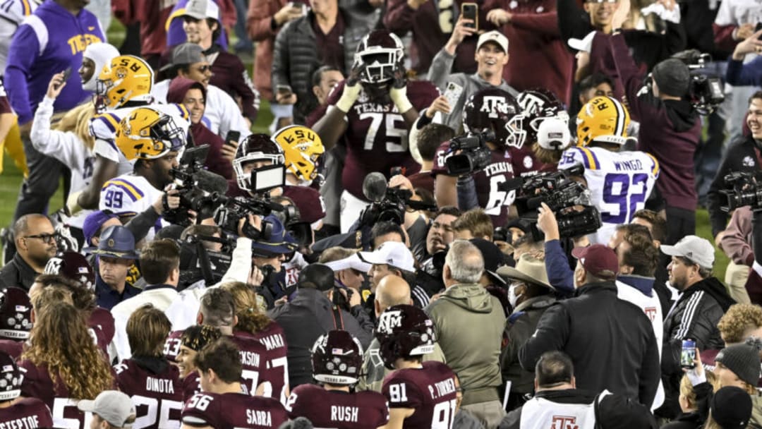 Nov 26, 2022; College Station, Texas, USA; Texas A&M Aggies head coach Jimbo Fisher and LSU Tigers head coach Brian Kelly meet amongst the crowd after the game at Kyle Field. Mandatory Credit: Maria Lysaker-USA TODAY Sports