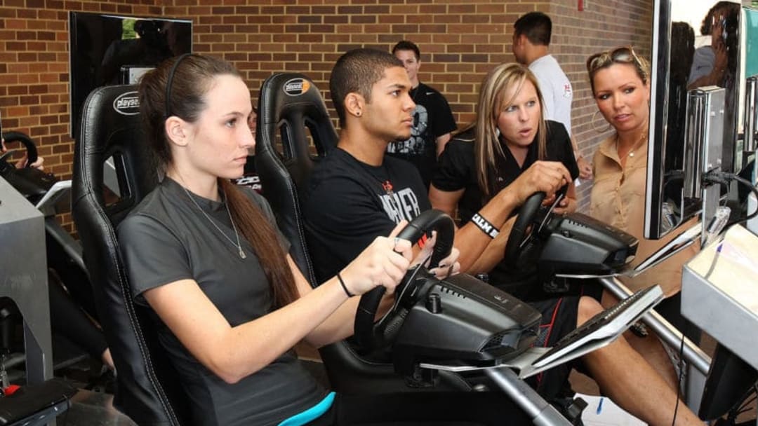 HAMPTON, VA - OCTOBER 16: (L-R)Amber Colvin of Mooresville, North Carolina and Devon Amos of Rio Ranch, New Mexico take their turns on the IRacing simulators during the NASCAR Drive For Diversity Combine at Hampton University on October 16, 2012 in Hampton, Virginia. (Photo by Tom Whitmore/Getty Images for NASCAR)