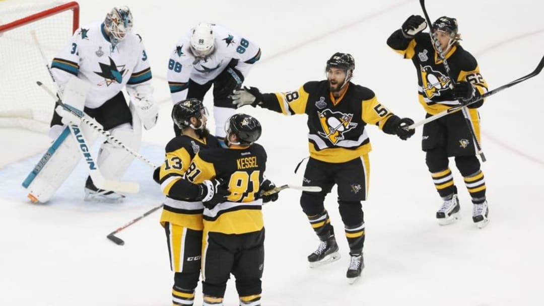 May 30, 2016; Pittsburgh, PA, USA; Pittsburgh Penguins center Nick Bonino (13) celebrates with teammates after scoring a goal past San Jose Sharks goalie Martin Jones (31) in the third period game one of the 2016 Stanley Cup Final at Consol Energy Center. Mandatory Credit: Charles LeClaire-USA TODAY Sports