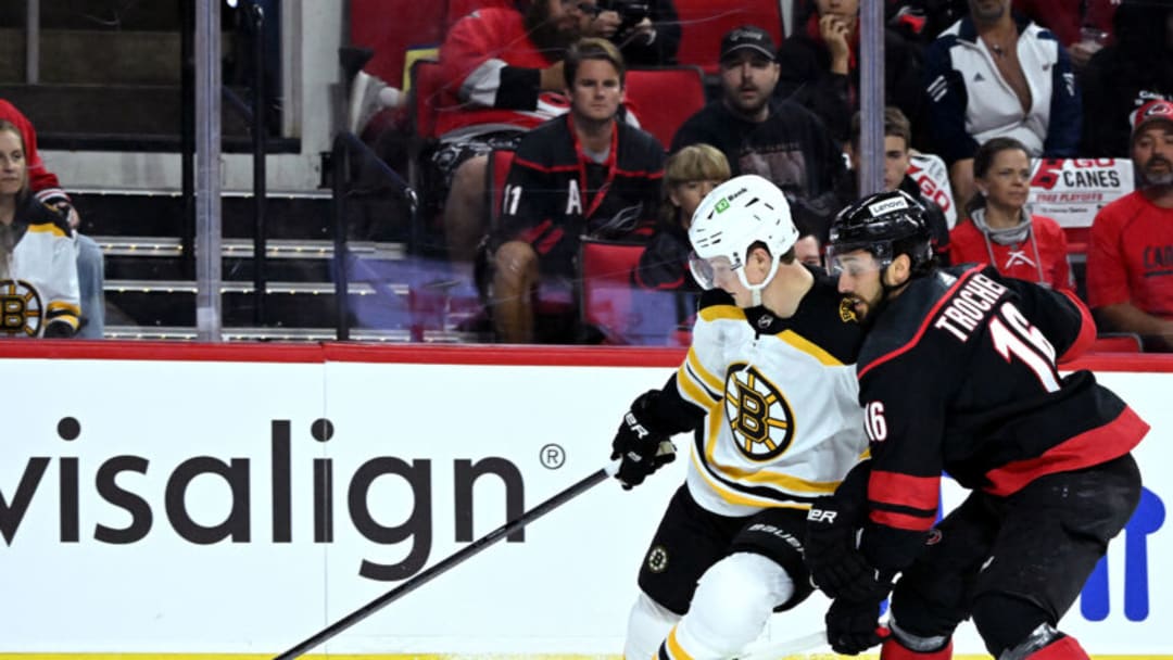 RALEIGH, NORTH CAROLINA - MAY 02: Trent Frederic #11 of the Boston Bruins battles Vincent Trocheck #16 of the Carolina Hurricanes for the puck during the first period of Game One of the First Round of the 2022 Stanley Cup Playoffs at PNC Arena on May 02, 2022 in Raleigh, North Carolina. (Photo by Grant Halverson/Getty Images)