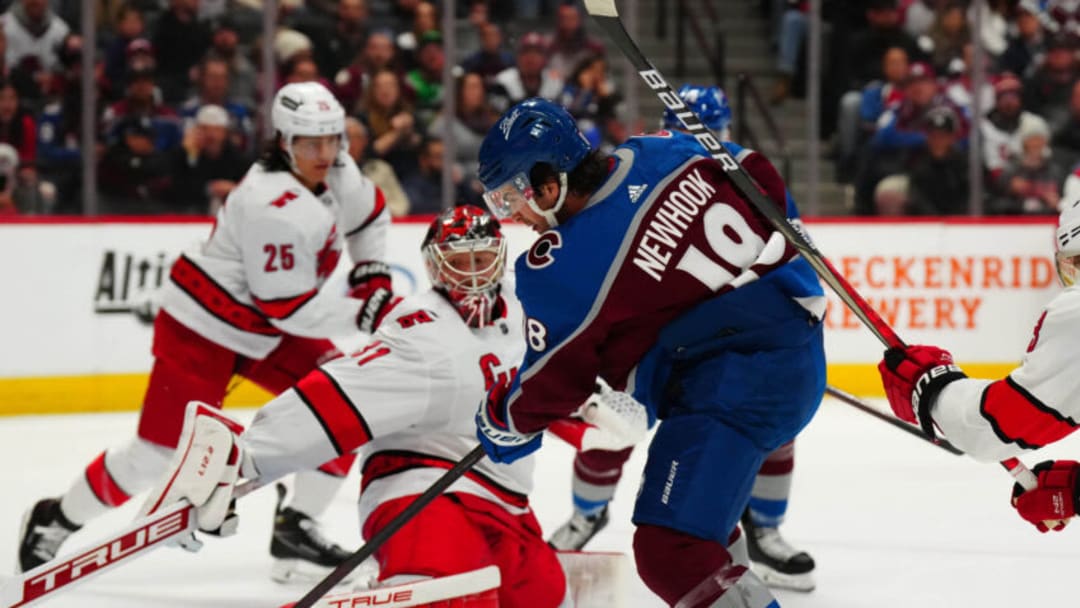 Apr 16, 2022; Denver, Colorado, USA; Colorado Avalanche center Alex Newhook (18) scores past Carolina Hurricanes goaltender Frederik Andersen (31) in the second period at Ball Arena. Mandatory Credit: Ron Chenoy-USA TODAY Sports