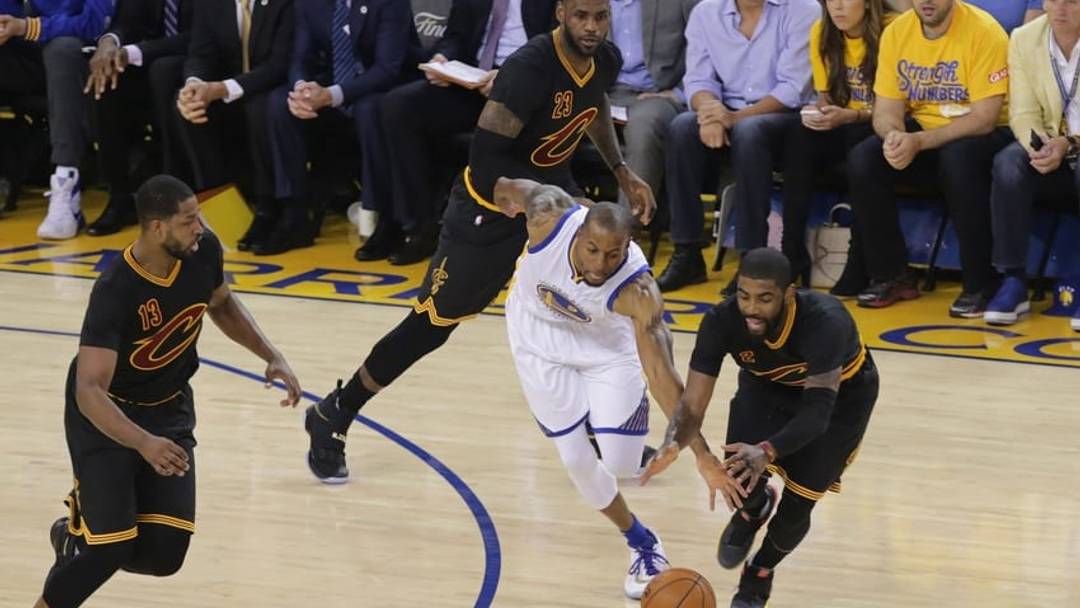 June 13, 2016; Oakland, CA, USA; Golden State Warriors forward Andre Iguodala (9) plays for the ball against Cleveland Cavaliers forward LeBron James (23), guard Kyrie Irving (2) and center Tristan Thompson (13) during the first half in game five of the NBA Finals at Oracle Arena. Mandatory Credit: Kelley L Cox-USA TODAY Sports