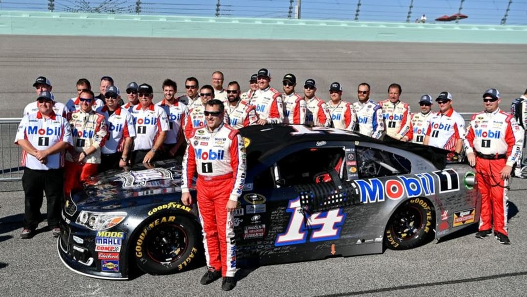 Nov 20, 2016; Homestead, FL, USA; NASCAR Sprint Cup Series driver Tony Stewart (14) poses for a picture with team before the Ford Ecoboost 400 at Homestead-Miami Speedway. Mandatory Credit: Jasen Vinlove-USA TODAY Sports