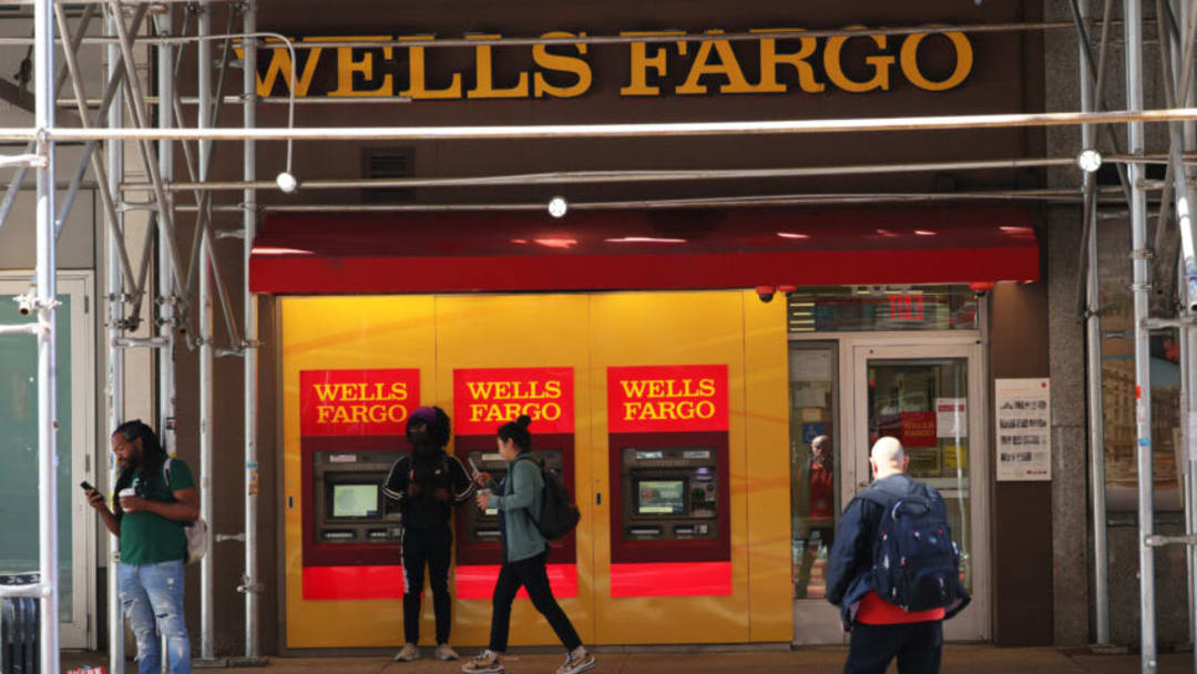 NEW YORK, NEW YORK - JUNE 10: People walk past a Wells Fargo Bank on June 10, 2022 in New York City. Federal prosecutors in Manhattan have opened up a criminal investigation into Wells Fargo to determine whether the bank’s hiring practices broke the law after a New York Times investigation uncovered the bank was conducting interviews with women and people of color for available positions where the hiring had already been made. (Photo by Michael M. Santiago/Getty Images)