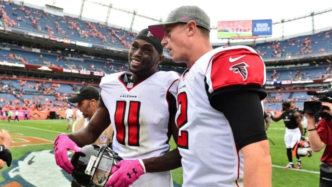 Oct 9, 2016; Denver, CO, USA; Atlanta Falcons wide receiver Julio Jones (11) and quarterback Matt Ryan (2) celebrate the win over the Denver Broncos in the second half at Sports Authority Field at Mile High. The Falcons defeated the Broncos 23-16. Mandatory Credit: Ron Chenoy-USA TODAY Sports