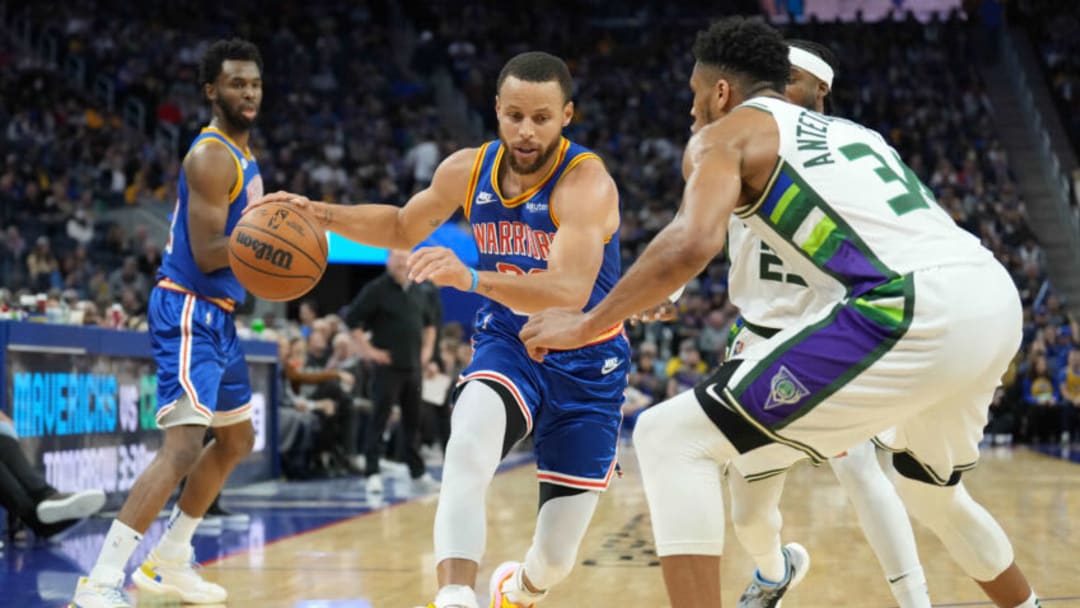 Mar 12, 2022; San Francisco, California, USA; Golden State Warriors guard Stephen Curry (30) dribbles against Milwaukee Bucks forward Giannis Antetokounmpo (34) during the third quarter at Chase Center. Mandatory Credit: Darren Yamashita-USA TODAY Sports