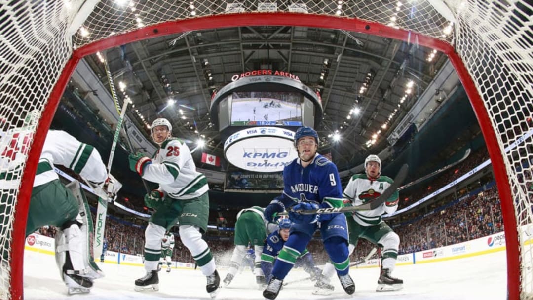VANCOUVER, BC - MARCH 9: Jonas Brodin #25 and Zach Parise #11 of the Minnesota Wild and Brendan Leipsic #9 of the Vancouver Canucks watch a loose puck during their NHL game at Rogers Arena March 9, 2018 in Vancouver, British Columbia, Canada. (Photo by Jeff Vinnick/NHLI via Getty Images)
