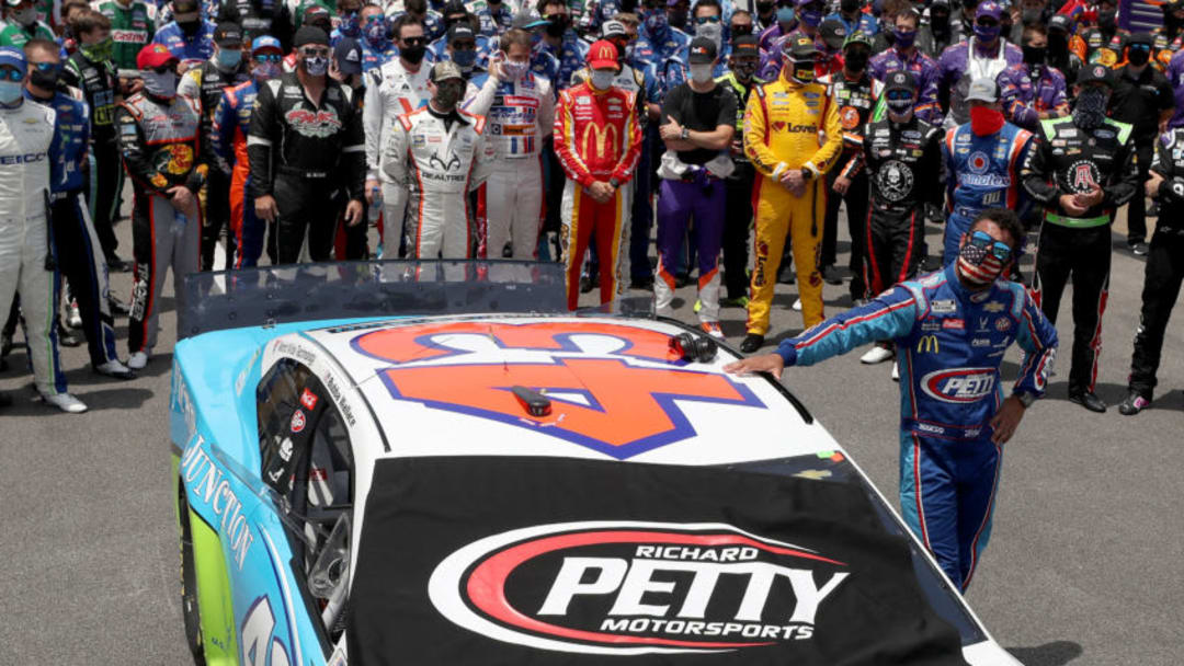 TALLADEGA, ALABAMA - JUNE 22: Bubba Wallace, driver of the #43 Victory Junction Chevrolet, takes a moment by his car after NASCAR drivers pushed him to the front of the grid as a sign of solidarity with the driver prior to the NASCAR Cup Series GEICO 500 at Talladega Superspeedway on June 22, 2020 in Talladega, Alabama. A noose was found in the garage stall of NASCAR driver Bubba Wallace at Talladega Superspeedway a week after the organization banned the Confederate flag at its facilities. (Photo by Chris Graythen/Getty Images)