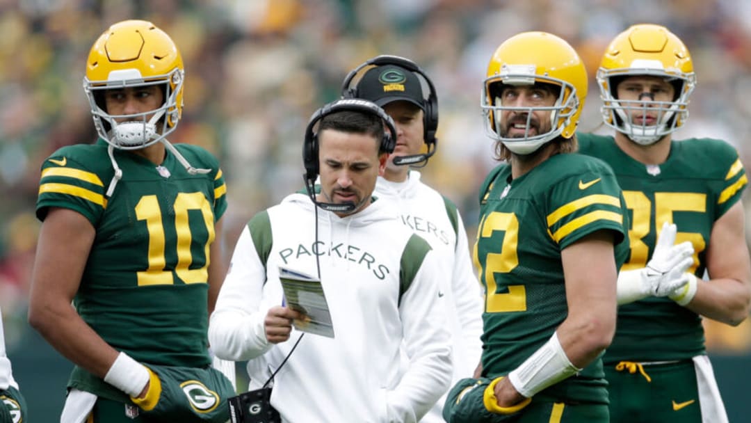 GREEN BAY, WISCONSIN - OCTOBER 24: Aaron Rodgers #12 talks with Green Bay Packers head coach Matt LaFleur as Jordan Love #10 listens during the game against the Washington Football Team at Lambeau Field on October 24, 2021 in Green Bay, Wisconsin. Green Bay defeated Washington 24-10. (Photo by John Fisher/Getty Images)