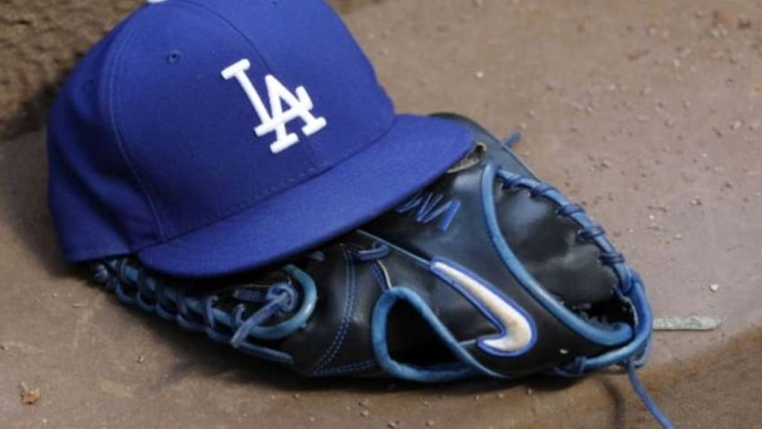 Aug 12, 2014; Atlanta, GA, USA; Detailed view of Los Angeles Dodgers hat and glove in the dugout against the Atlanta Braves in the third inning at Turner Field. Mandatory Credit: Brett Davis-USA TODAY Sports