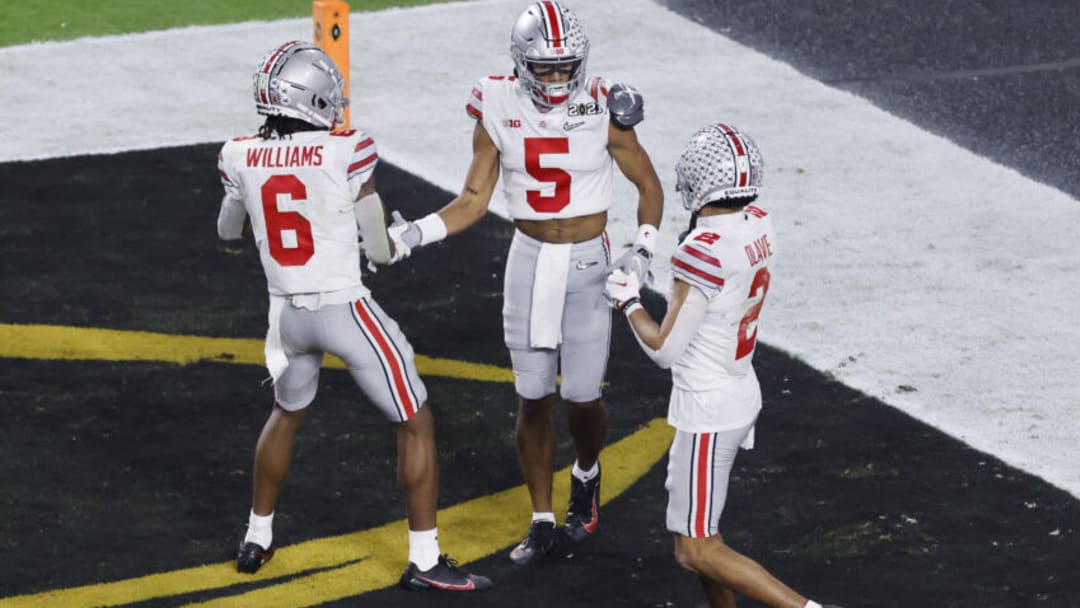 MIAMI GARDENS, FLORIDA - JANUARY 11: Garrett Wilson #5 of the Ohio State Buckeyes celebrates his 20 yard touchdown alongside Jameson Williams #6 and Chris Olave #2 during the third quarter of the College Football Playoff National Championship game against the Alabama Crimson Tide at Hard Rock Stadium on January 11, 2021 in Miami Gardens, Florida. (Photo by Michael Reaves/Getty Images)