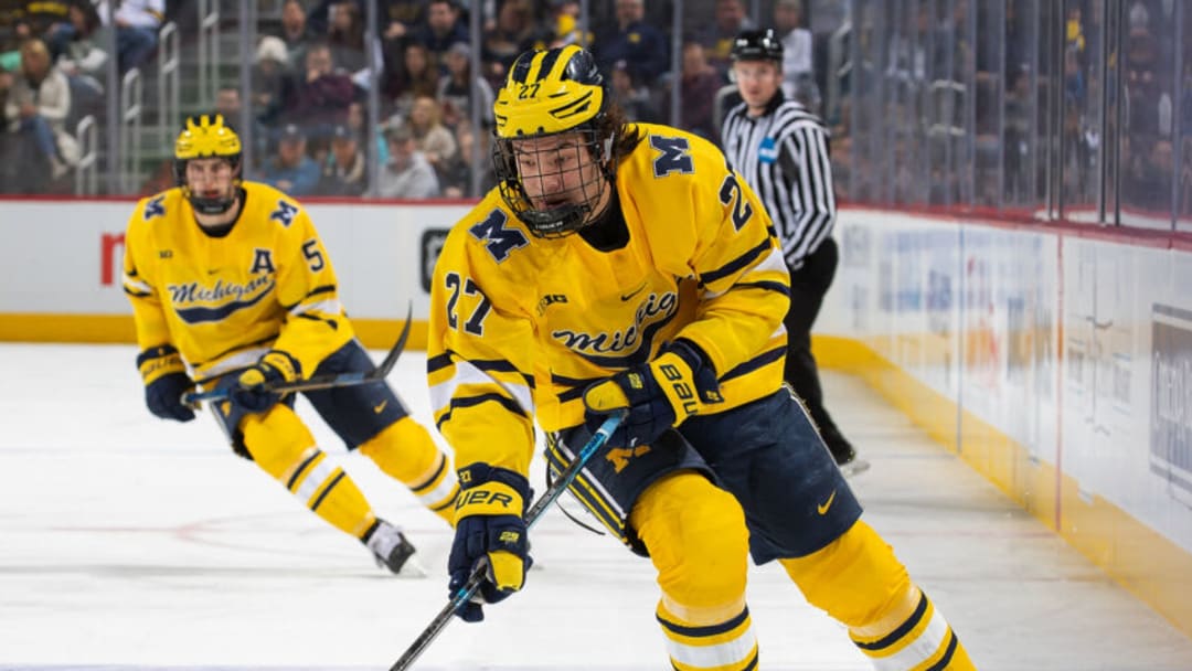 DETROIT, MI - FEBRUARY 17: Nolan Moyle #27 of the Michigan Wolverines skates up ice with the puck against the Michigan State Spartans during the first period of the annual NCAA hockey game, Duel in the D at Little Caesars Arena on February 17, 2020 in Detroit, Michigan. The Wolverines defeated the Spartans 4-1. (Photo by Dave Reginek/Getty Images)