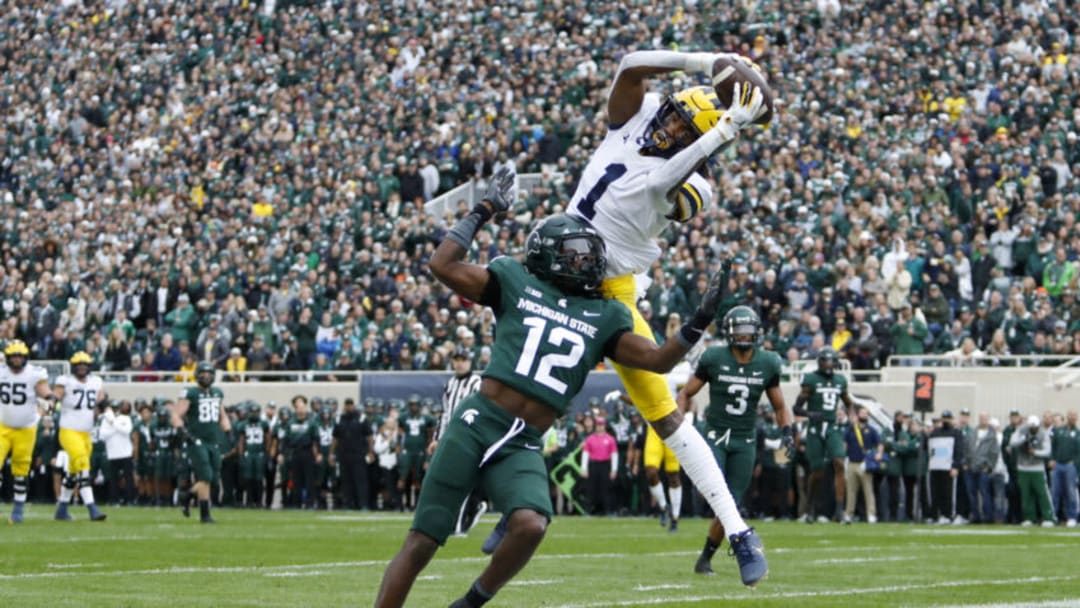 Oct 30, 2021; East Lansing, Michigan, USA; Michigan Wolverines wide receiver Andrel Anthony (1) makes a catch for a touchdown against Michigan State Spartans cornerback Chester Kimbrough (12) during the second quarter at Spartan Stadium. Mandatory Credit: Raj Mehta-USA TODAY Sports